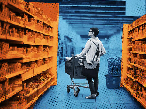 woman with grocery cart looking at grocery store shelf