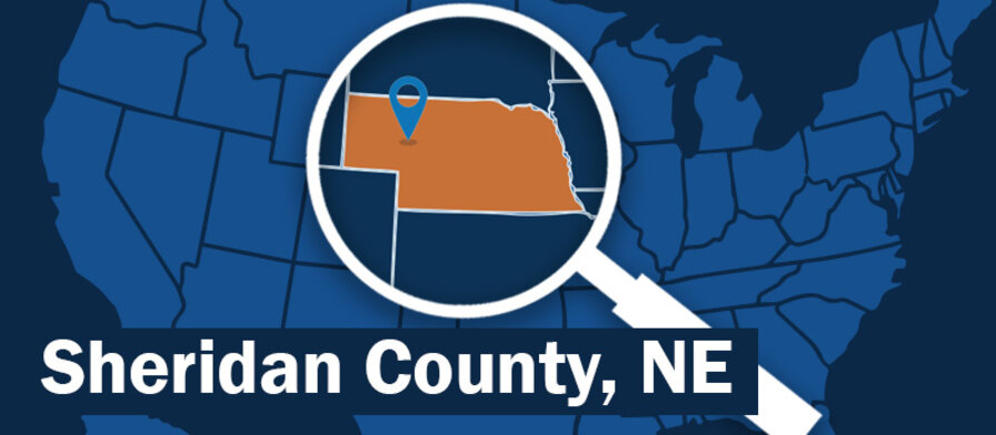 blue map of the U. S. with magnifying glass highlighting nebraska with a location marker over the Sheridan County area